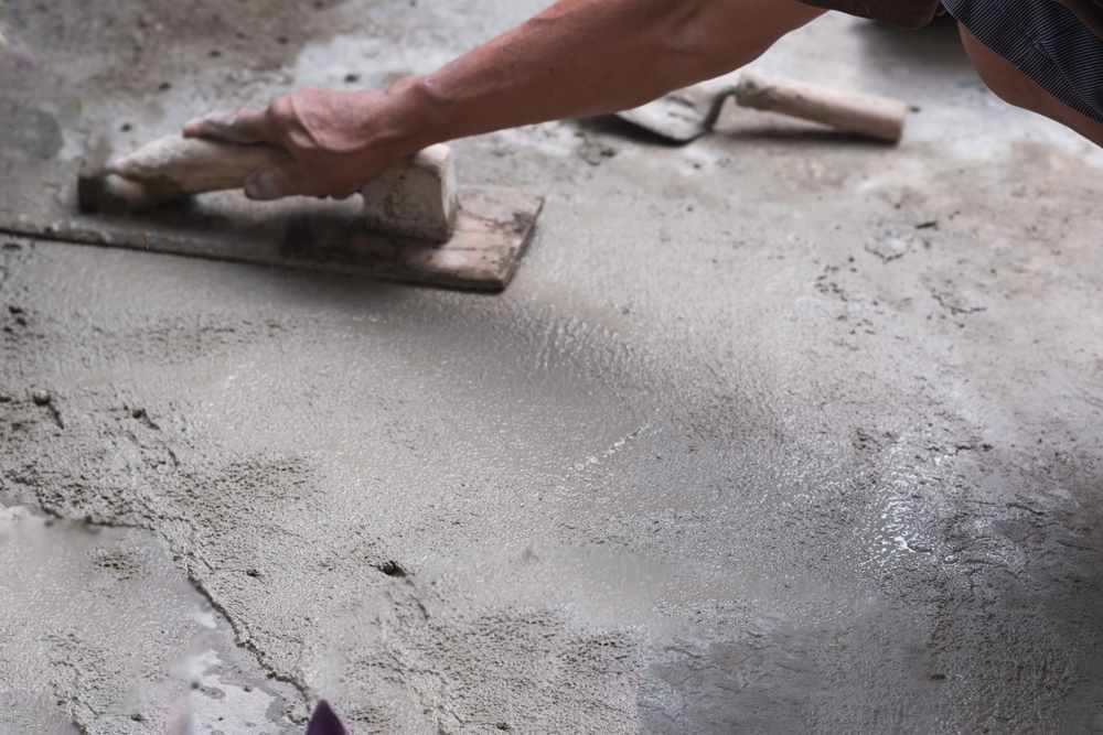 Concrete contractor smoothing wet concrete slab for McInroy Contractors LLC / Vernon County Ready Mix
