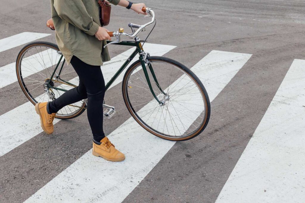 Pedestrian pushes bike over crosswalk