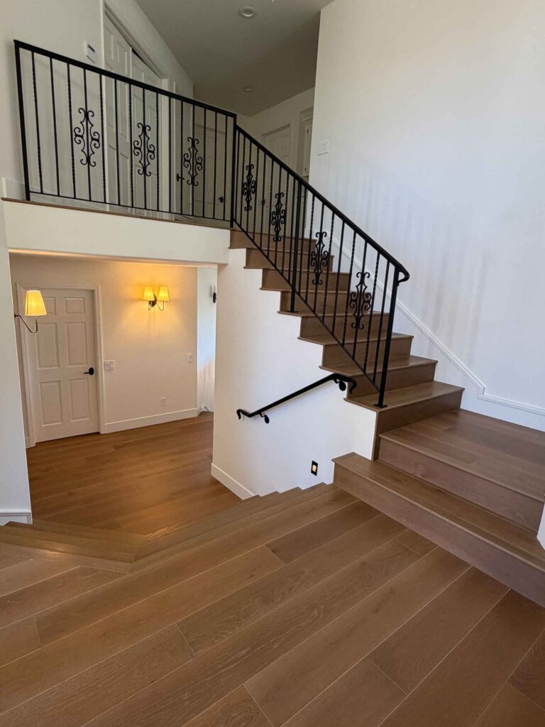 Angello's Floor Coverings installed wood-look tile flooring and staircase in a modern home entry