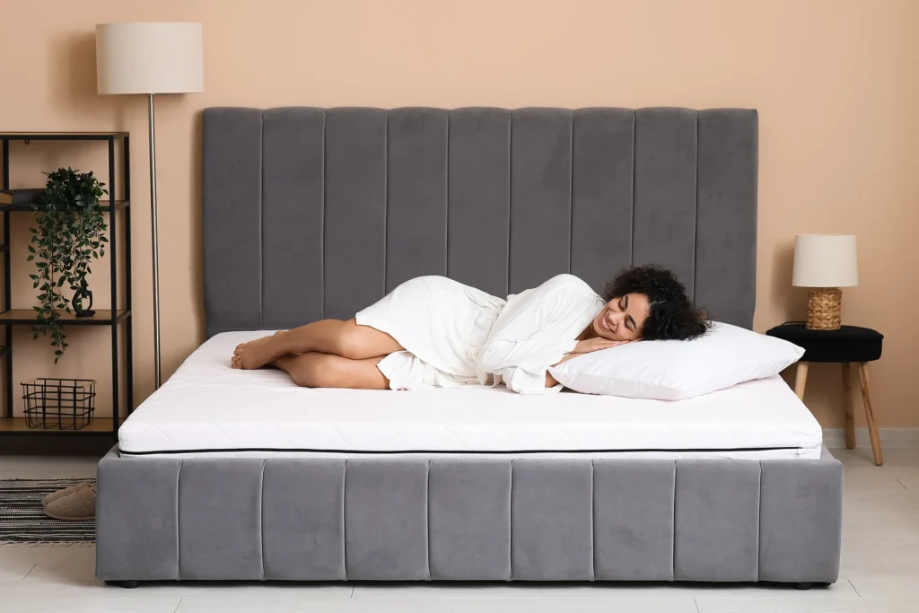 Woman on mattress bed smiling