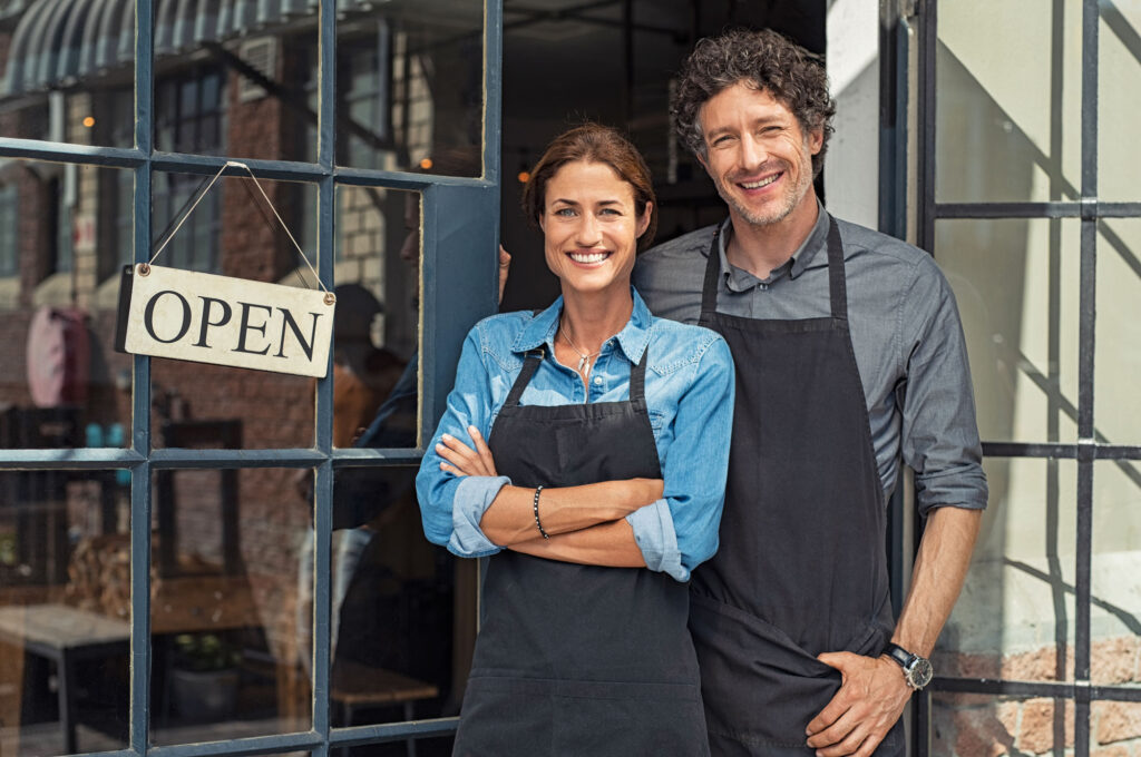 Two cheerful small business owners smiling