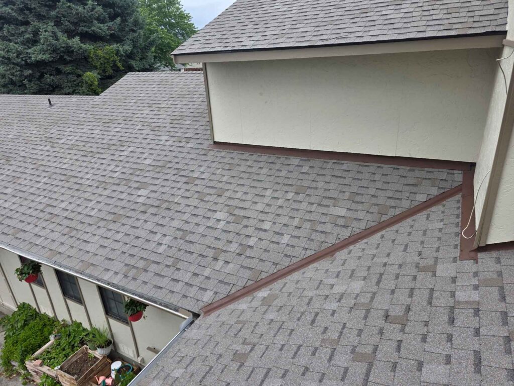 A+ Quality Construction roof installation photo showing asphalt shingle roofing and gutters on a residential home