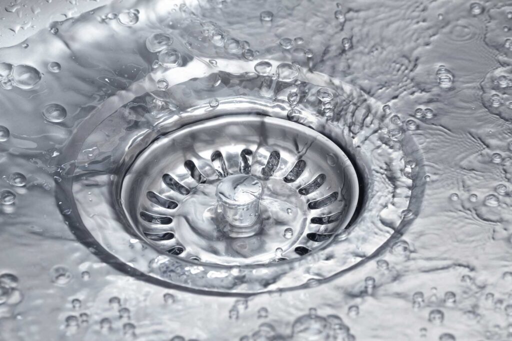 Close-up of a septic tank drain cover with water and bubbles for Best Jet Septic