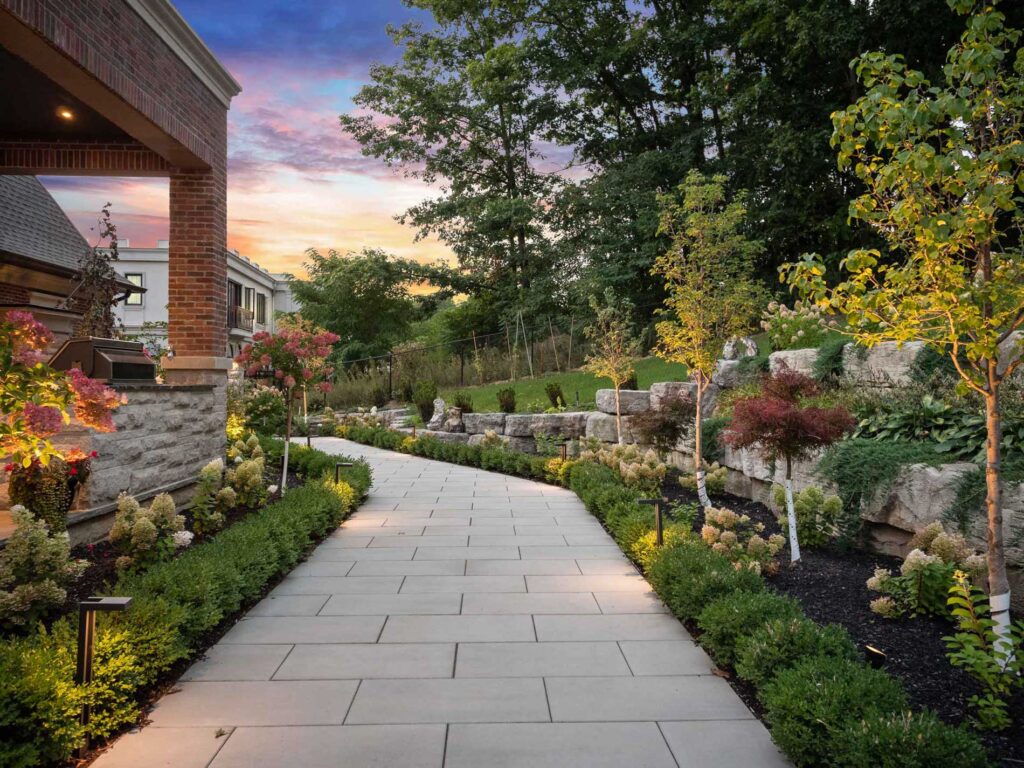landscaping around interlocking walkway with landscape lighting