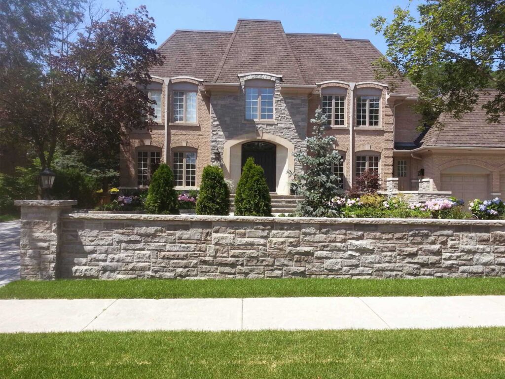 Stone Wall in front of house with pillars