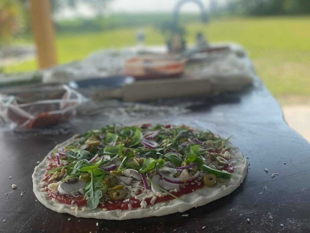 Outdoor kitchen with pizza on countertop