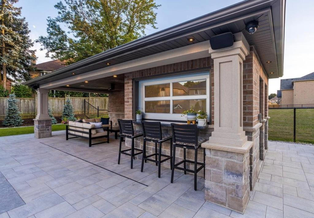 Stone Kings Landscaping outdoor patio with stone fireplace and seating area