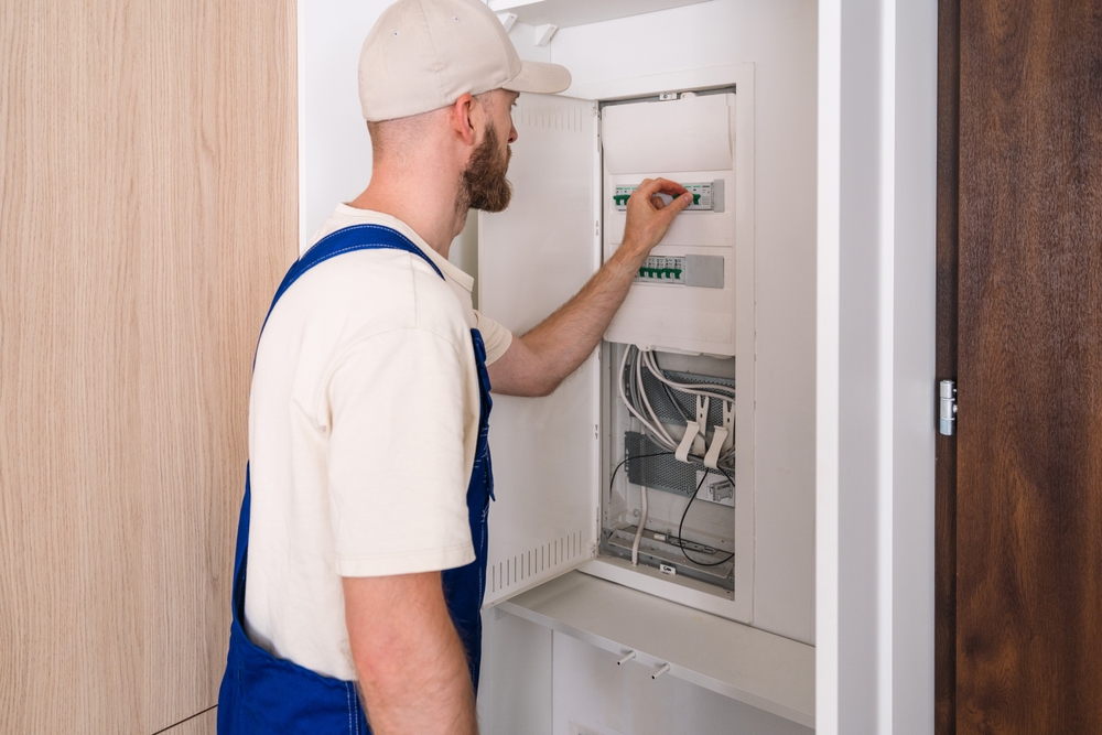 Electrician from Light Of This World Electric installing an electrical panel