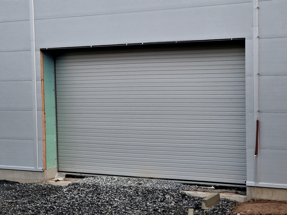 AmCo Door Co. roll-up garage door installed on industrial building