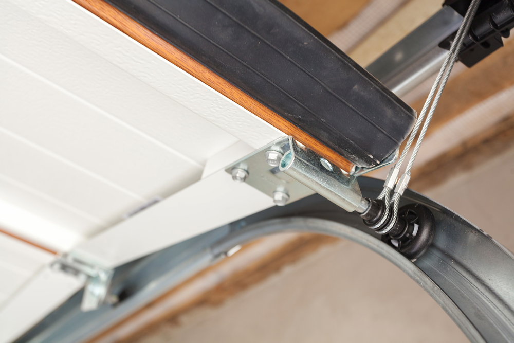 Garage door opener mechanism and cables on an overhead door
