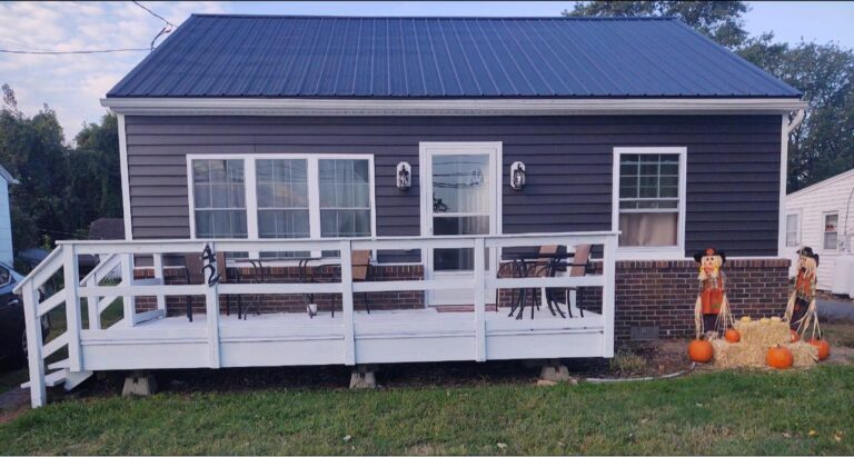Boyd's Custom Remodeling provide this small house in Dover with new metal roof, siding, deck and more.
