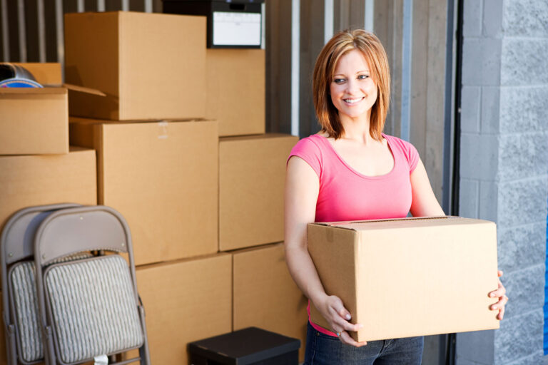 Woman Carrying Box To Storage Unit