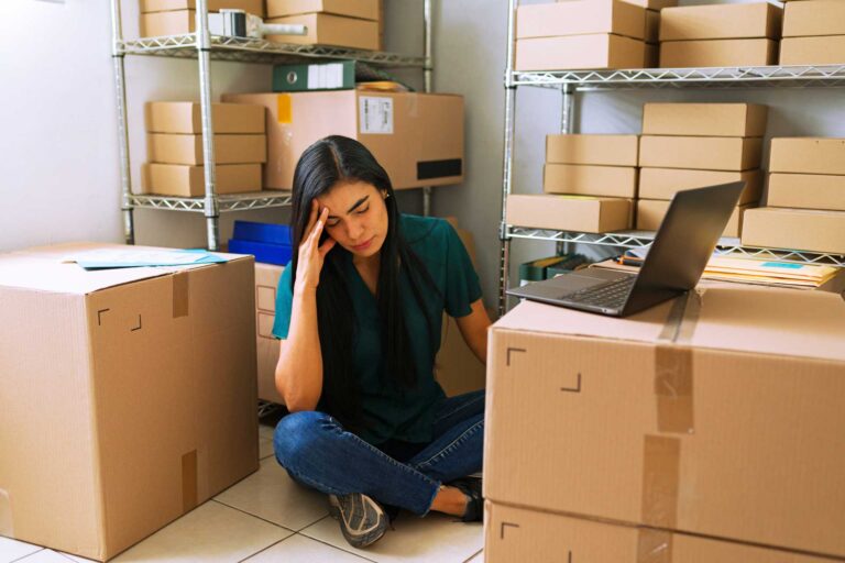 stressed, boxes, shelves, woman sitted on the floor