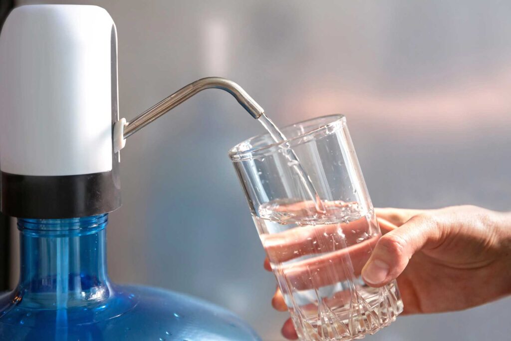 Water glass on water cooler, gallon, dispenser