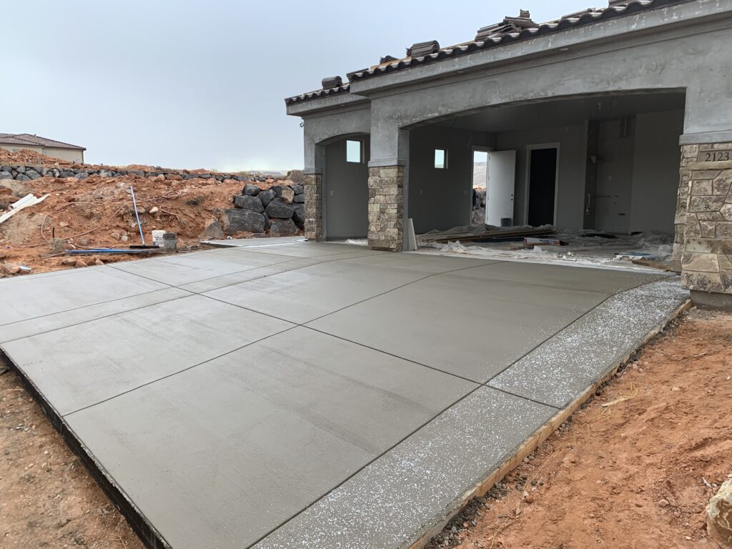 Jensen's Quality Concrete Inc. newly poured concrete slab and patio foundation at a residential construction site