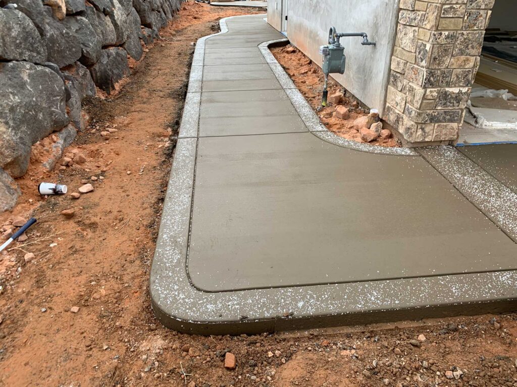 Jensen's Quality Concrete finished concrete walkway with edging and forms during construction