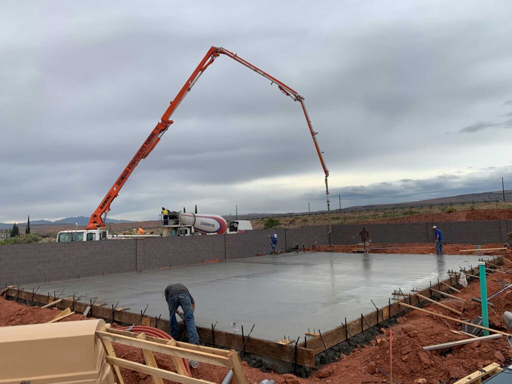 Jensen's Quality Concrete crew pouring and pumping concrete at a construction site