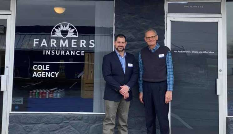 Cole Insurance Agency LLC representatives standing in front of a Farmers Insurance office