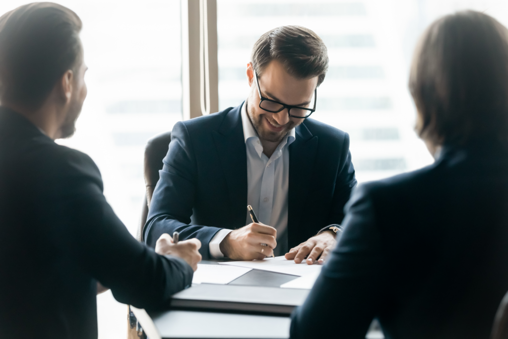 Cole Insurance Agency LLC agent meeting with clients at a business office table