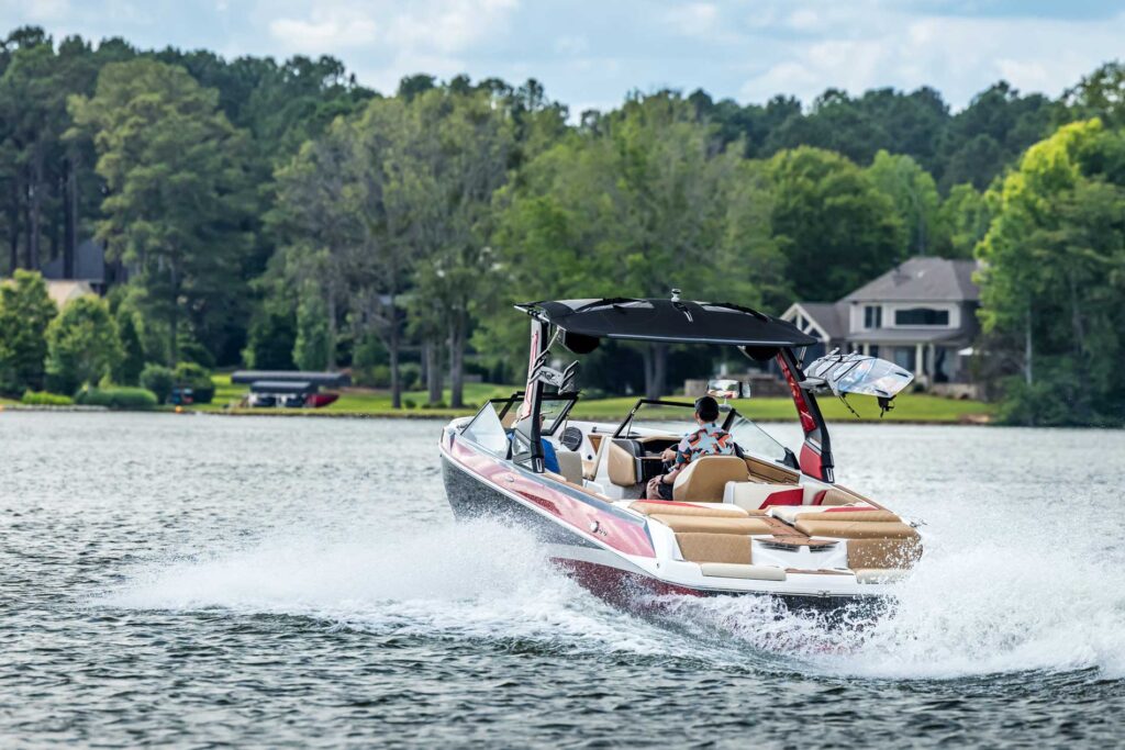 Cole Insurance Agency LLC promotional image of a powerboat on a lake with a shoreline house in the background