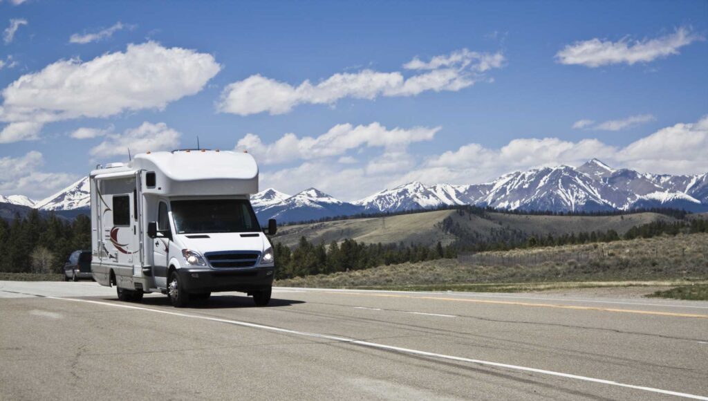 Cole Insurance Agency LLC vehicle on a highway with mountains and blue sky