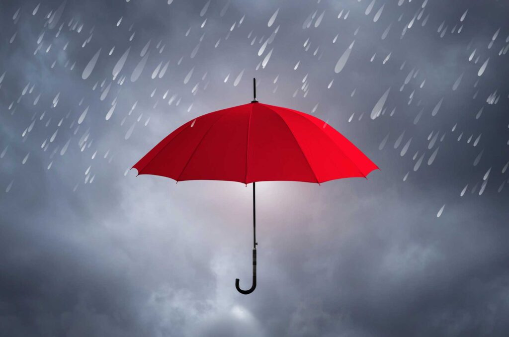 Red umbrella under rainy weather, representing Cole Insurance Agency LLC protection