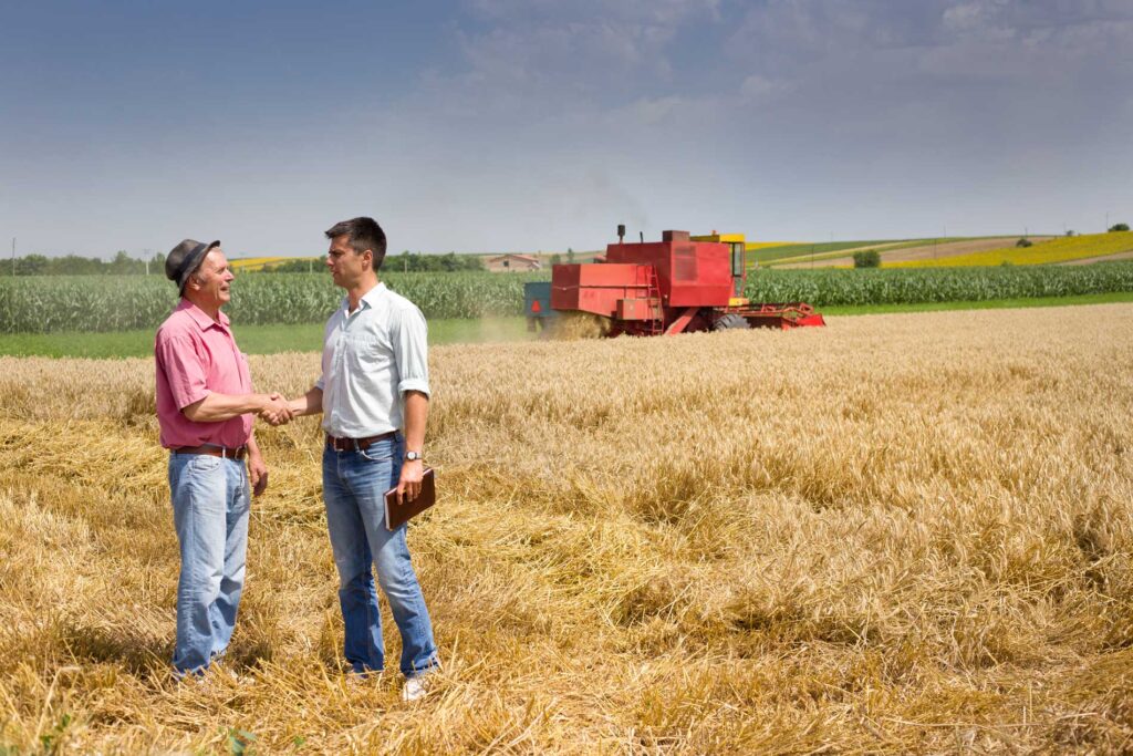 Cole Insurance Agency LLC representatives meeting farmers in a harvest field