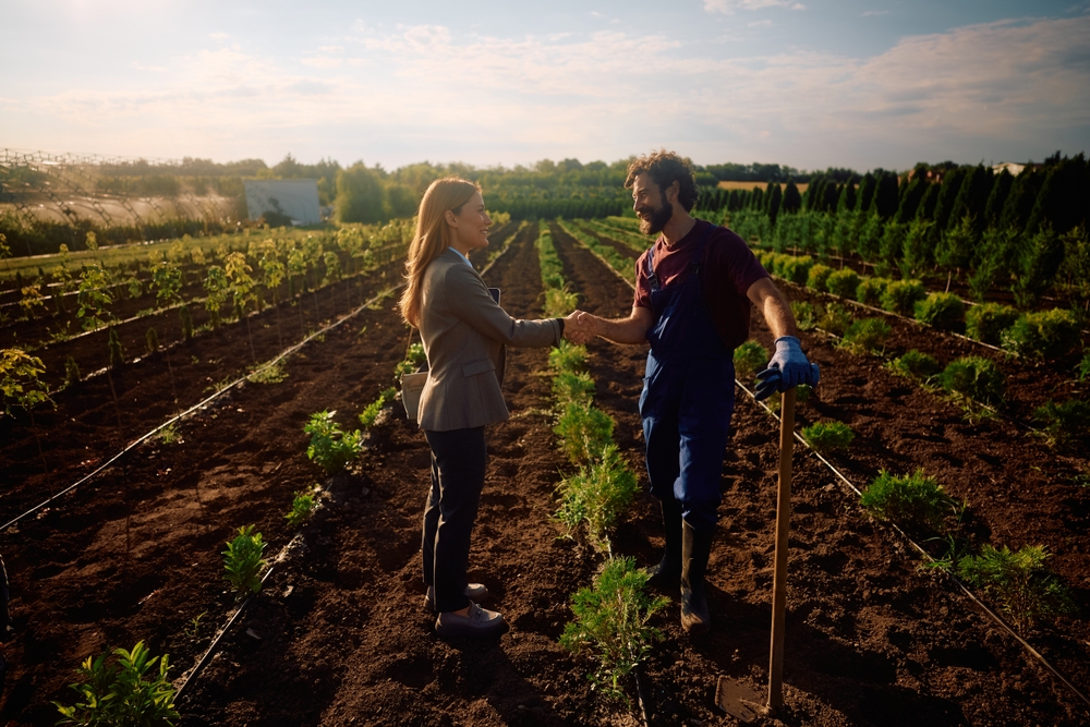 Cole Insurance Agency, LLC providing insurance help for a man and woman shaking hands in a farm field