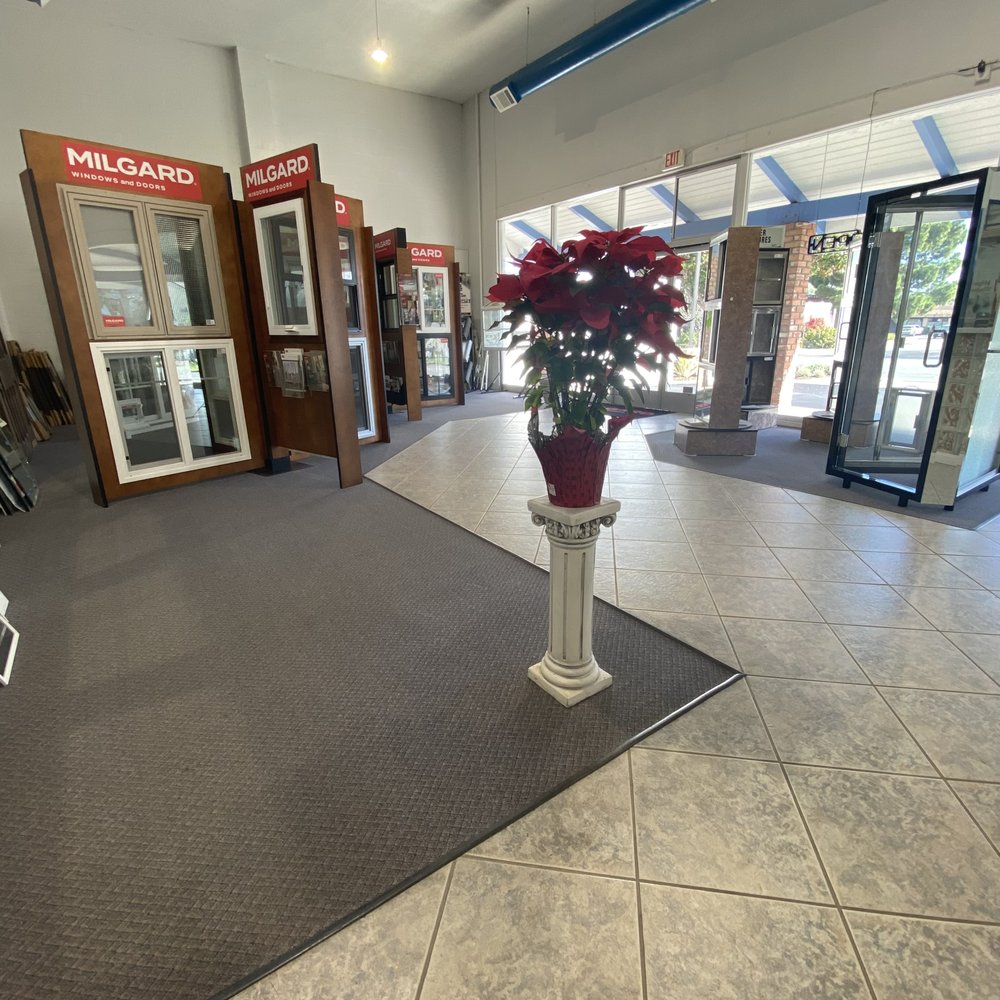 Mid Coast Glass showroom display of window and door products with signage
