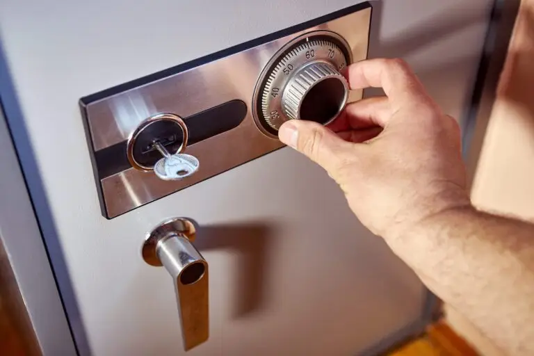 Hand unlocking a keyless safe lock with a dial and key