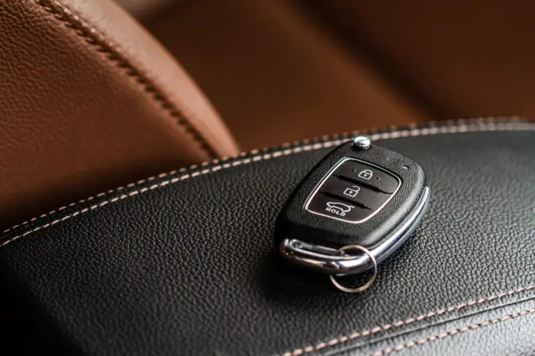 Car key fob with lock and unlock buttons on leather interior
