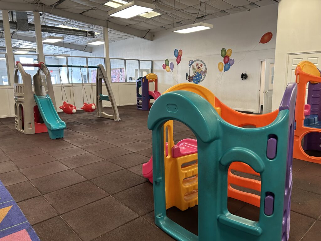 Country Kids Children's Center indoor play area with colorful playground equipment and balloons