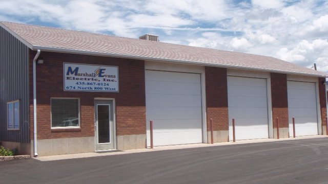 Marshall & Evans Electric Inc storefront exterior with garage doors and sign
