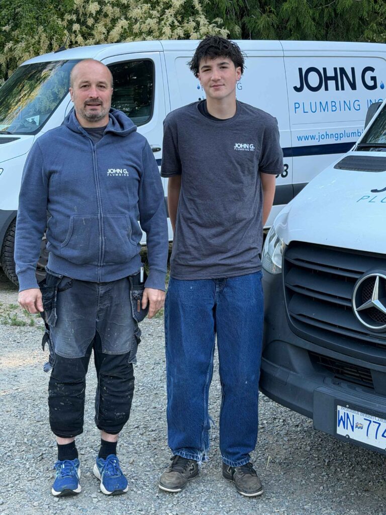 John G Plumbing Inc plumbers standing in front of company van
