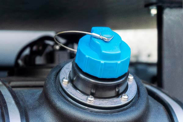 KJ's Repair Service Ltd vehicle repair showing a close-up of an engine bay component with a blue cap