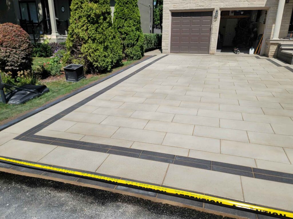 Northern Stone Design Inc. paved stone driveway and walkway in front of a garage