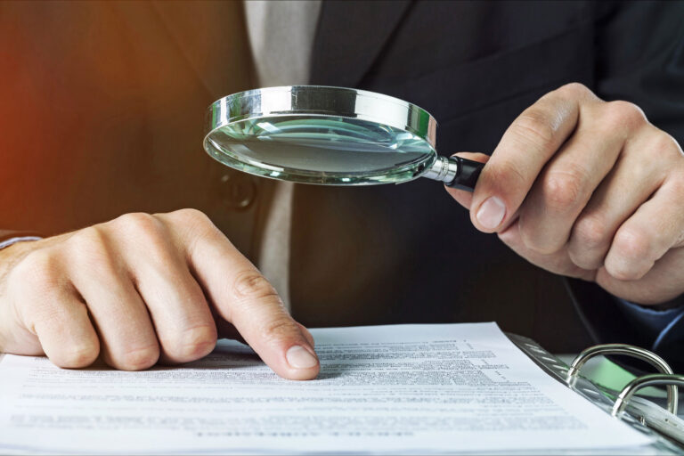 Barton County Title Co Inc professional title search with magnifying glass over legal documents