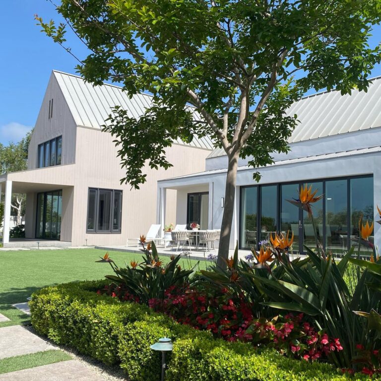 CB Paint & Decor modern white building exterior with landscaped garden and flowers