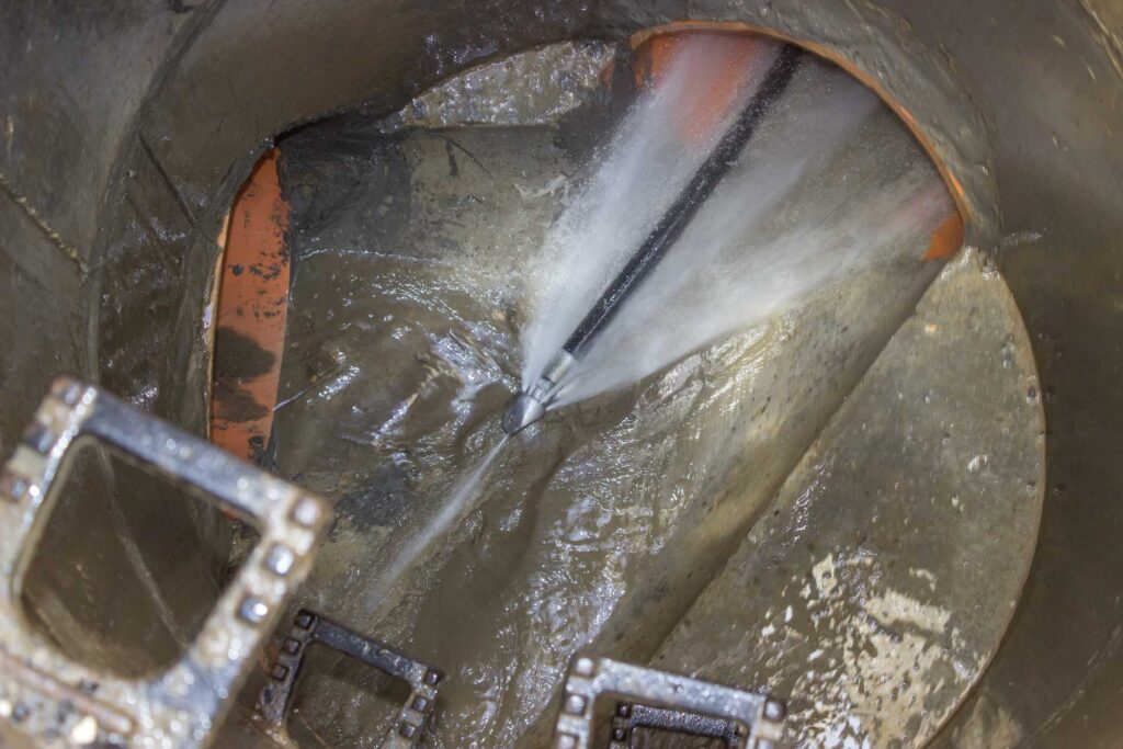 Skagit Sewer Specialists sewer line camera inspection with high-pressure water clearing a drain