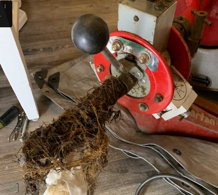 Skagit Sewer Specialists sewer cleaning equipment with red drain auger and tools