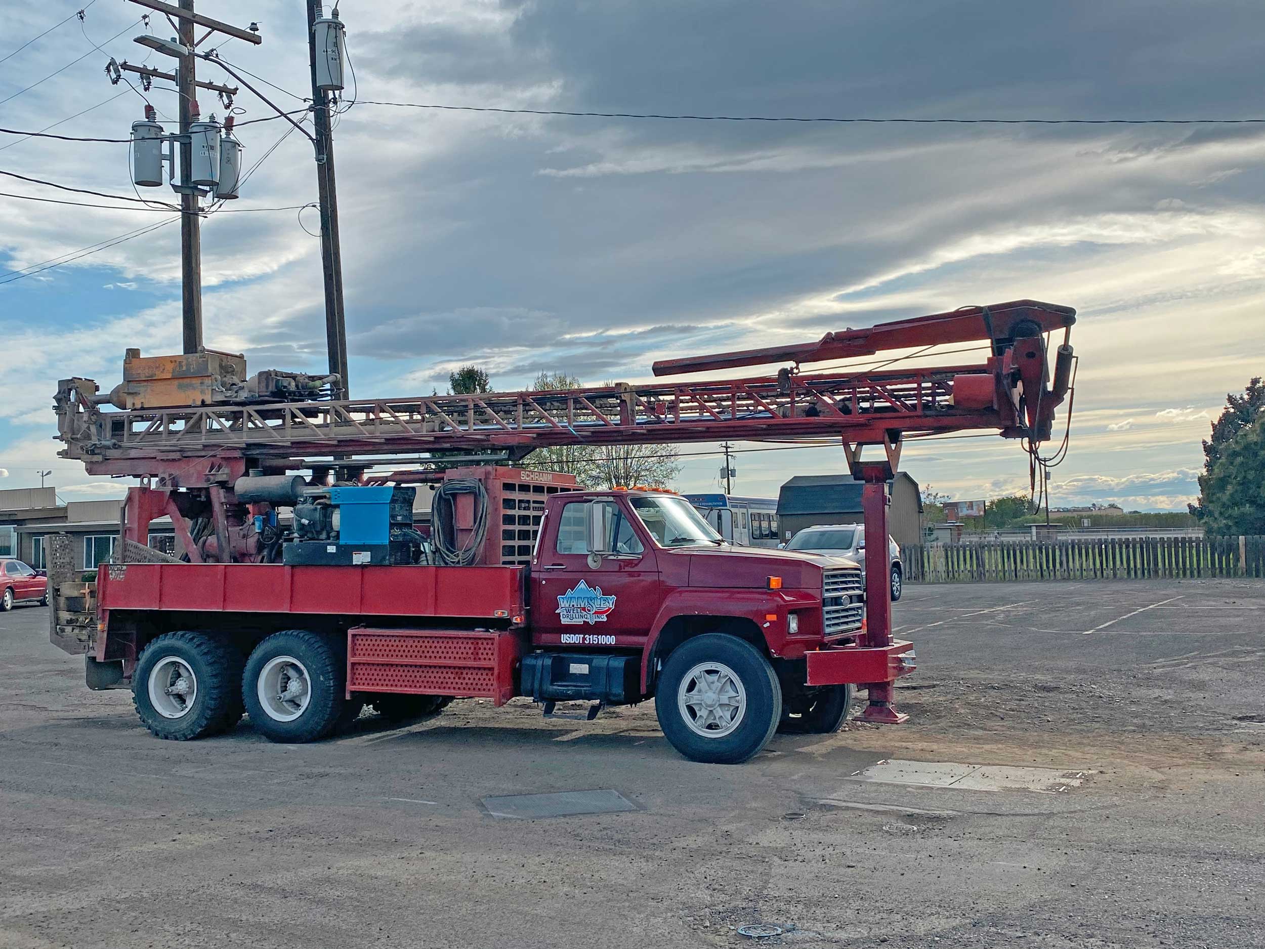 Wamsley Well Drilling Inc. drilling rig truck parked outdoors at a job site
