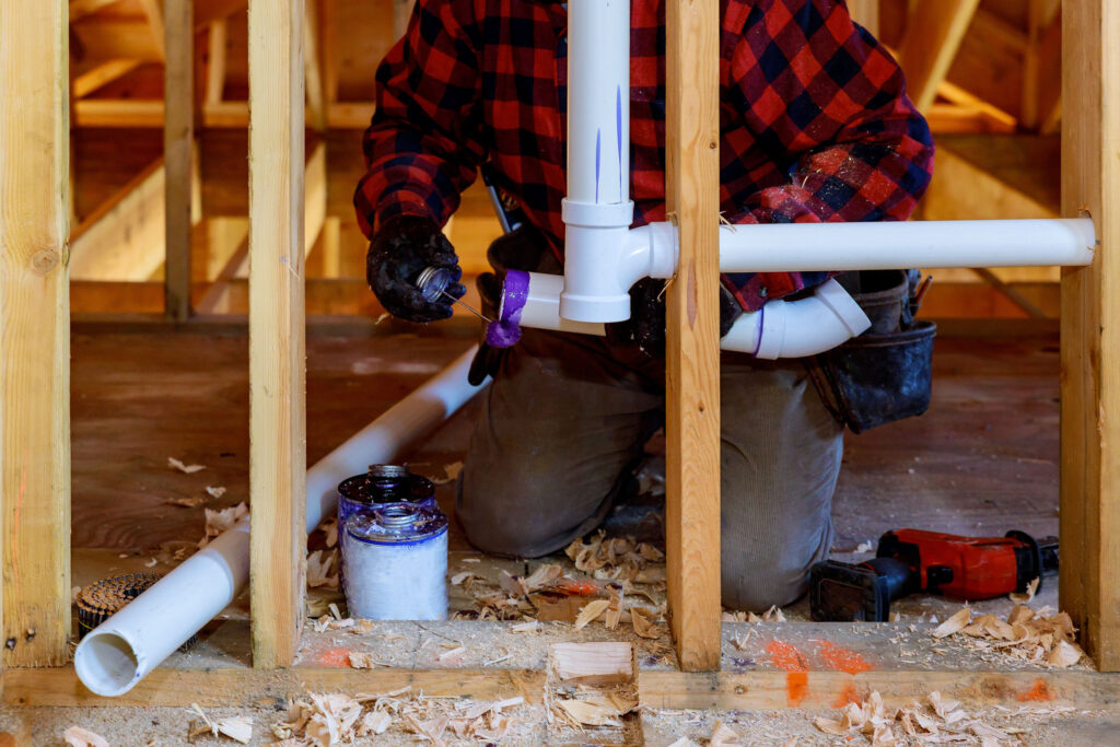 A plumber working on a pipe