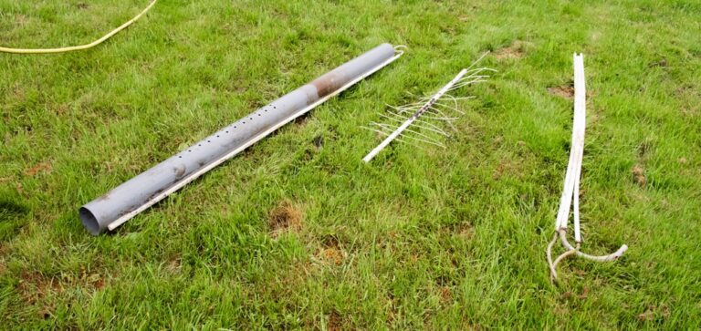Hillbilly Pumping & Hauling service image showing PVC pipes and grass-yard debris cleanup