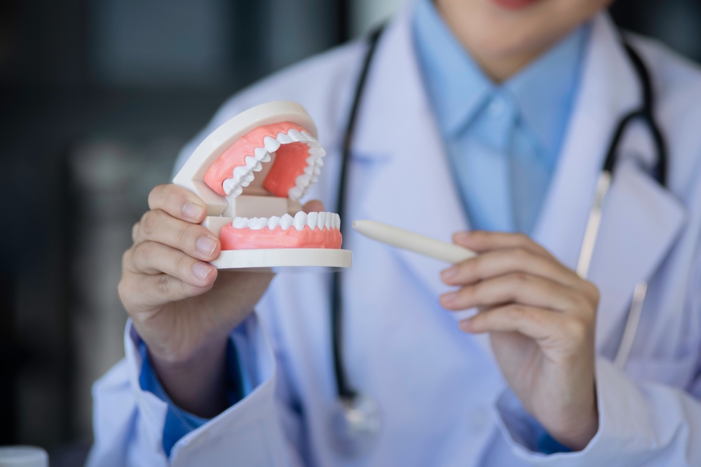 Woman smiling and showing her new dentures