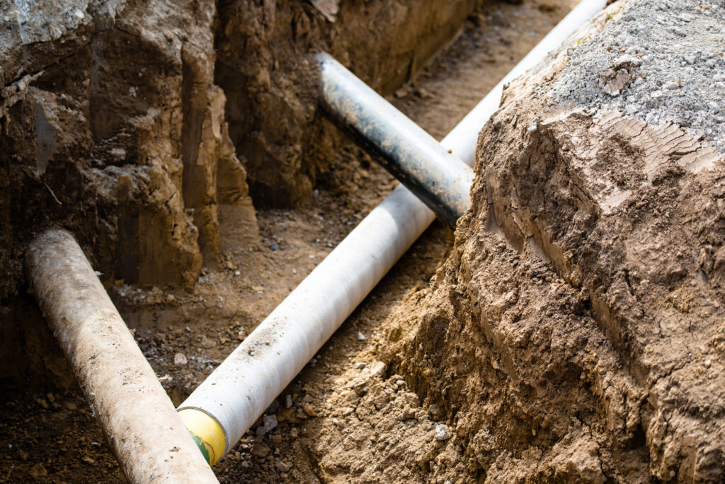 Sawtooth Plumbing & Heating Inc. underground plumbing installation with pipes in a trench
