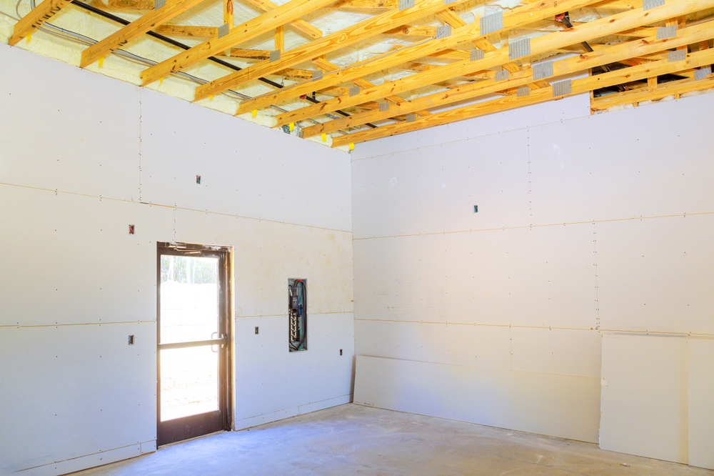 Jim's Lumber interior framing and exposed wooden ceiling beams in a new construction room