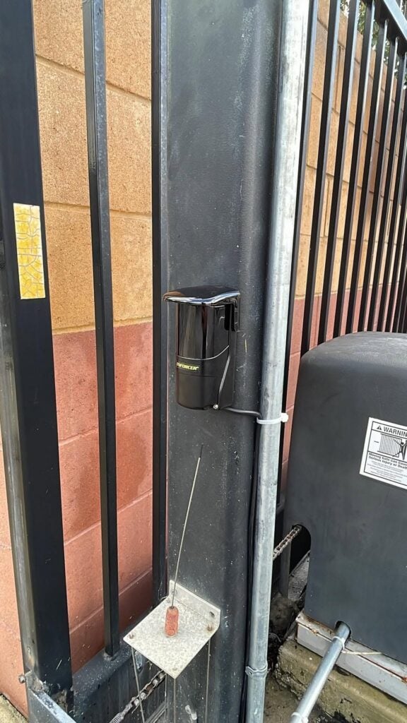 Pacific Overhead Door Service technician’s view of an automatic garage door opener installation and safety contact sensors