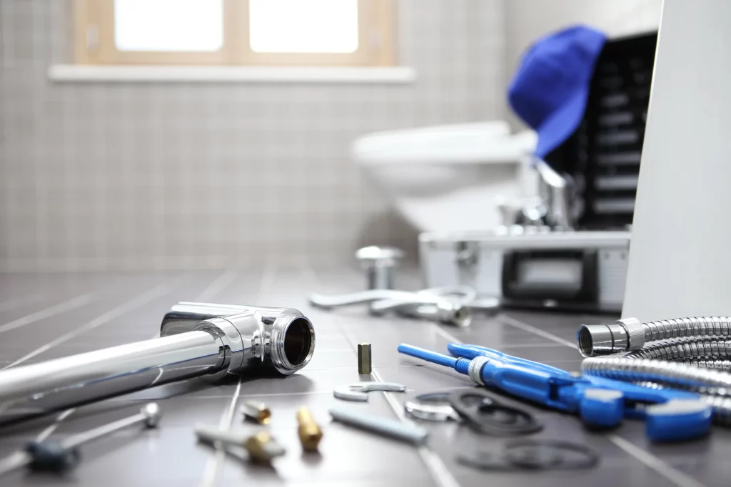 plumbing tools & fixtures on bathroom floor