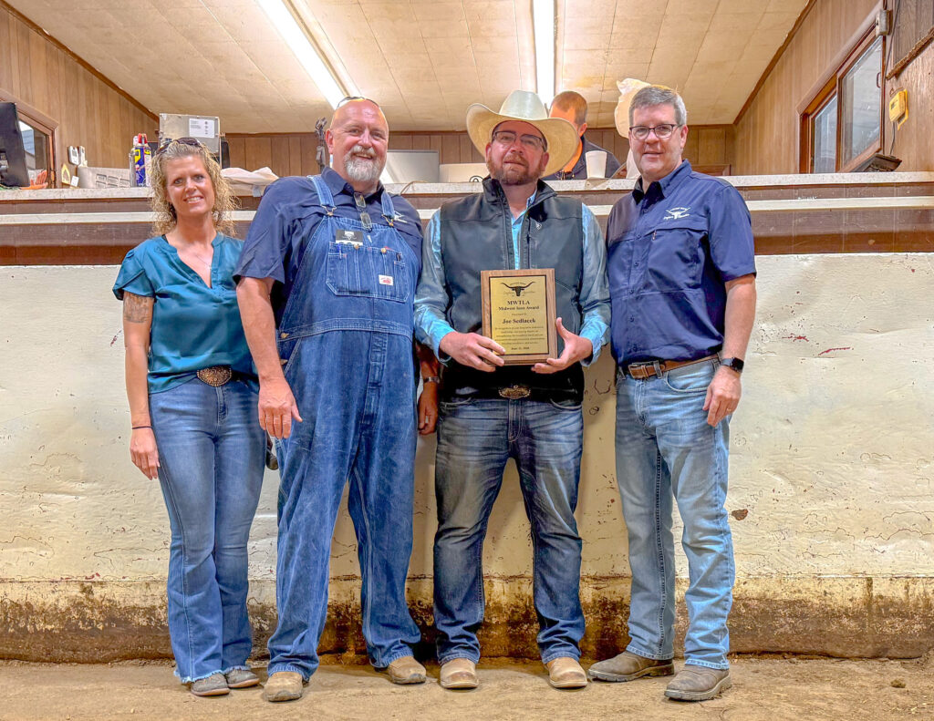 Midwest Texas Longhorn Association members holding an award plaque indoors
