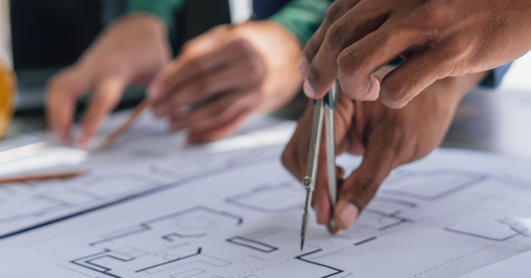 Two Architects collaborating and going over a house building plan